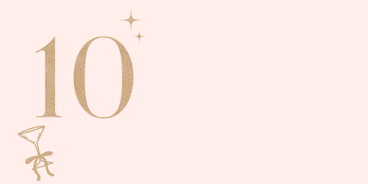 Gold number '10' with decorative elements on a light pink background